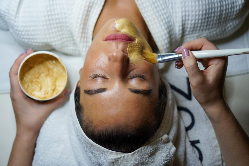 Woman enjoying gold face mask 