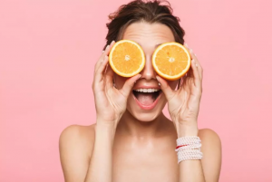 Woman smiling with oranges